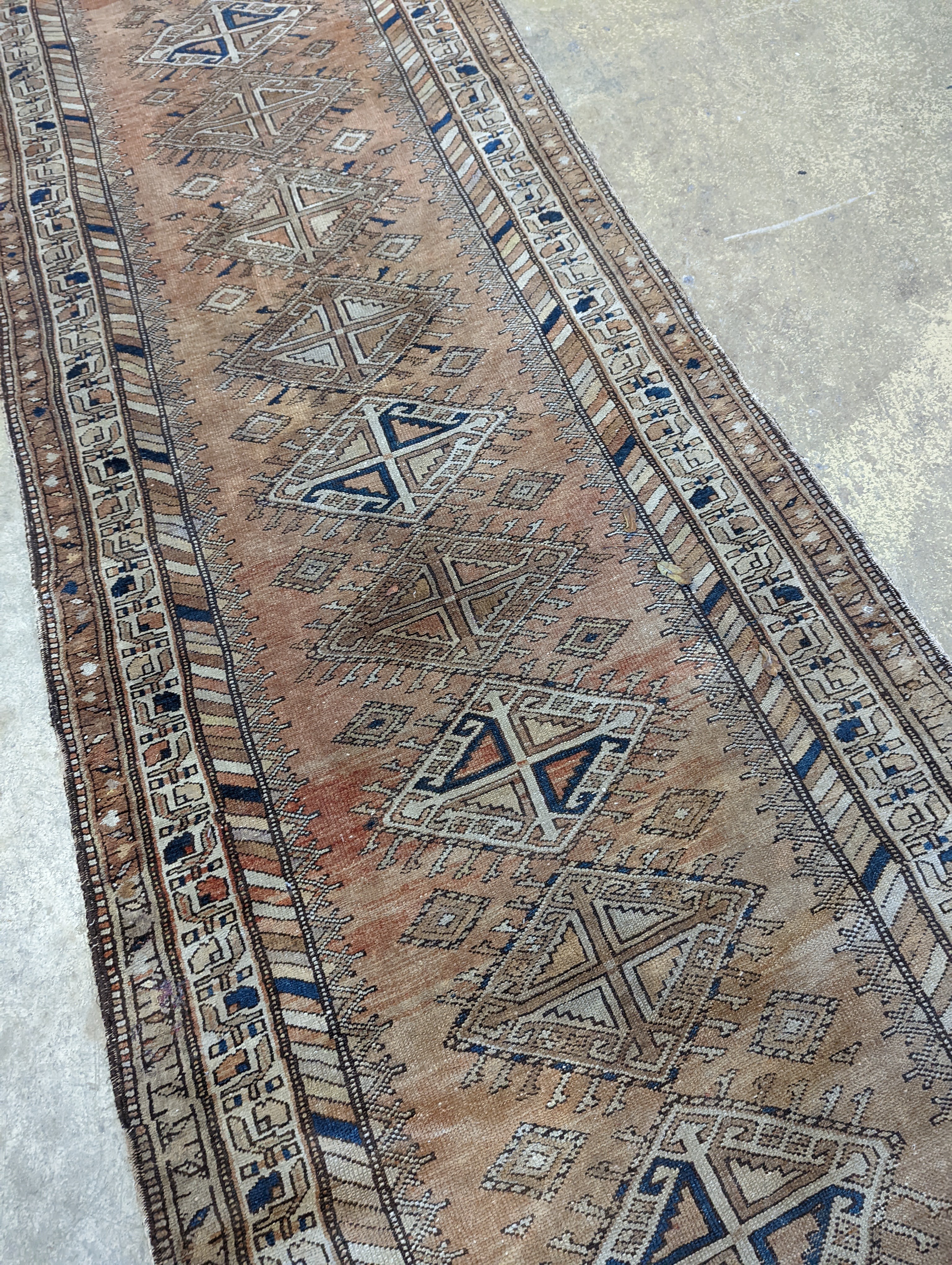 An antique Caucasian red ground runner, 372 x 106cm